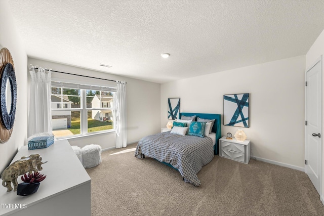 bedroom with carpet and a textured ceiling