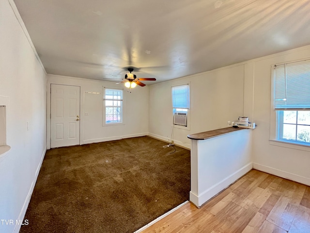 unfurnished room featuring ceiling fan, a wealth of natural light, and hardwood / wood-style floors