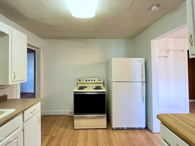 kitchen featuring white cabinets, light hardwood / wood-style flooring, and white appliances