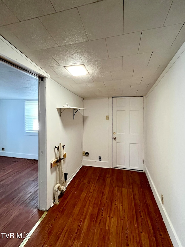 clothes washing area featuring dark hardwood / wood-style flooring