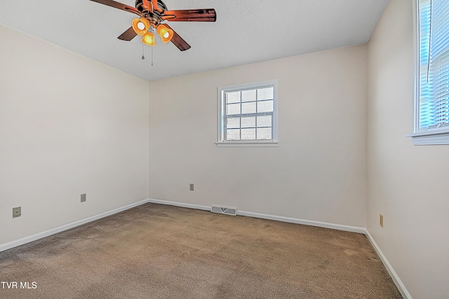 carpeted empty room with a textured ceiling and ceiling fan