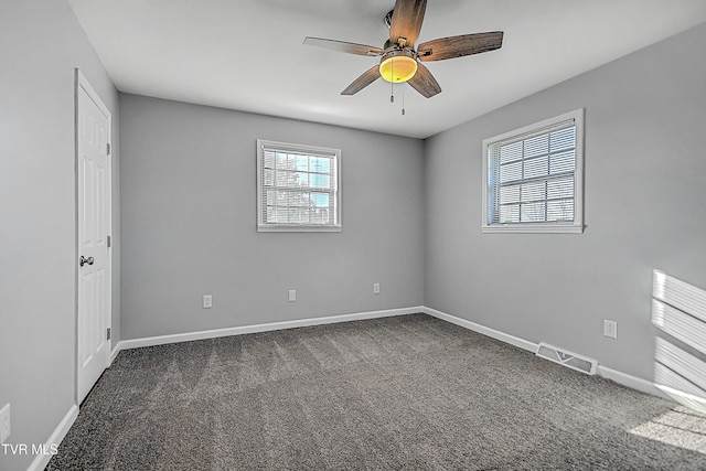 carpeted spare room featuring ceiling fan