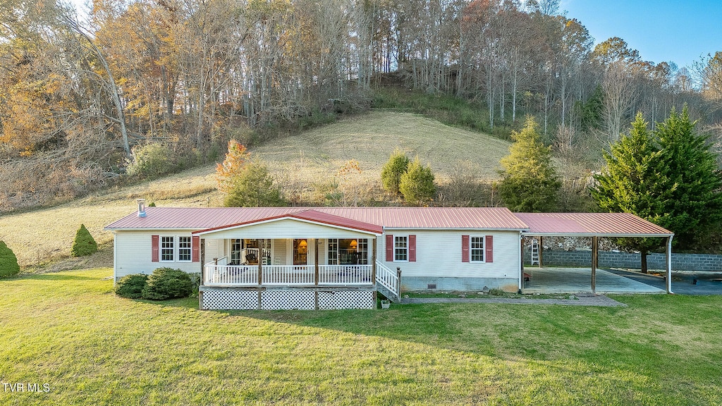 view of front facade with a front yard and a wooden deck