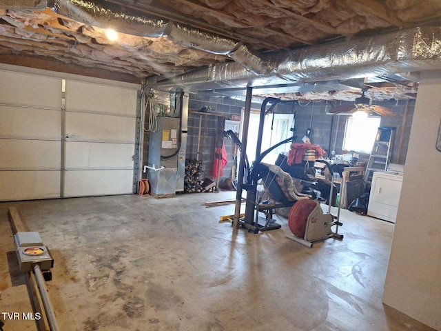 garage featuring washer / clothes dryer and heating unit