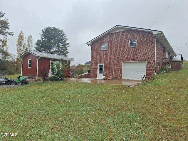 view of side of property featuring a yard and a garage