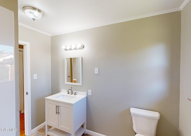 bathroom featuring toilet, ornamental molding, vanity, and hardwood / wood-style floors