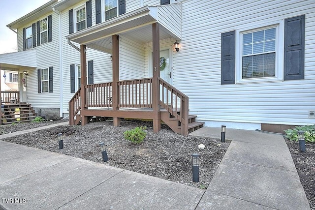 view of exterior entry with covered porch