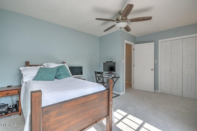 carpeted bedroom featuring baseboards, a textured ceiling, ceiling fan, and a closet
