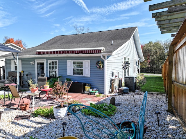 rear view of house with cooling unit and a patio