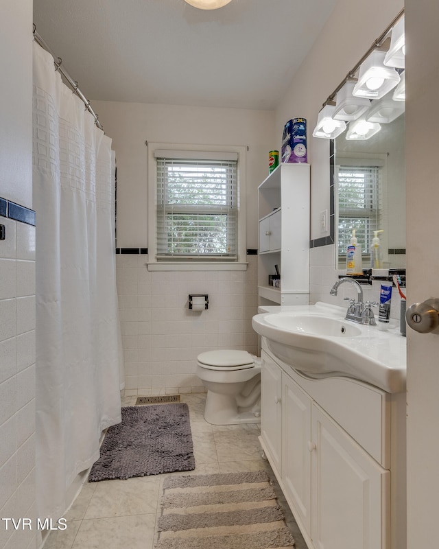 bathroom featuring tile patterned floors, toilet, tile walls, vanity, and a shower with shower curtain