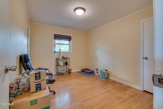 miscellaneous room featuring wood-type flooring and crown molding