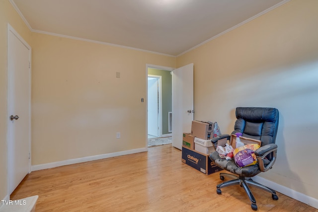 sitting room featuring light wood-type flooring and crown molding