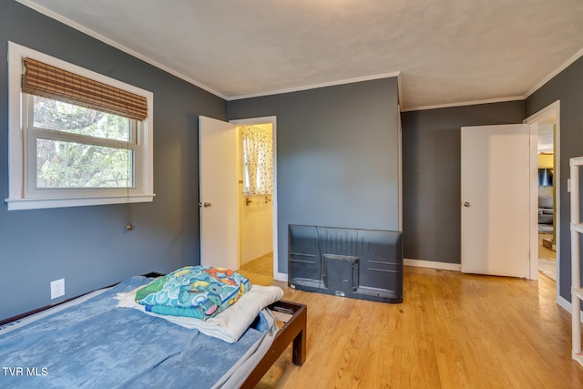 bedroom featuring light wood-type flooring and ornamental molding