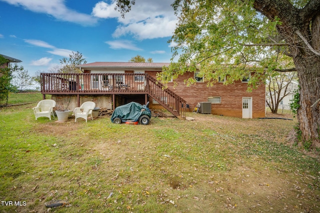 back of property with central AC, a yard, and a wooden deck