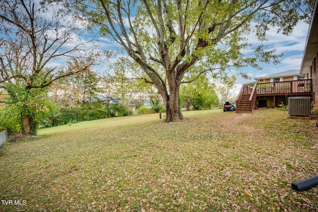 view of yard with central AC unit and a deck