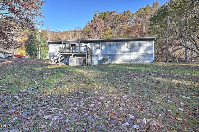 back of house featuring cooling unit and a lawn