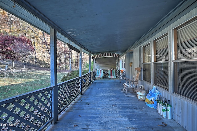 wooden deck featuring a lawn