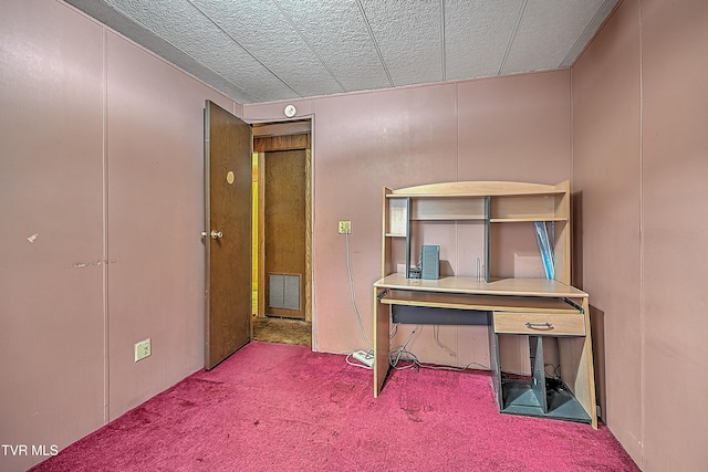 misc room with a textured ceiling and carpet