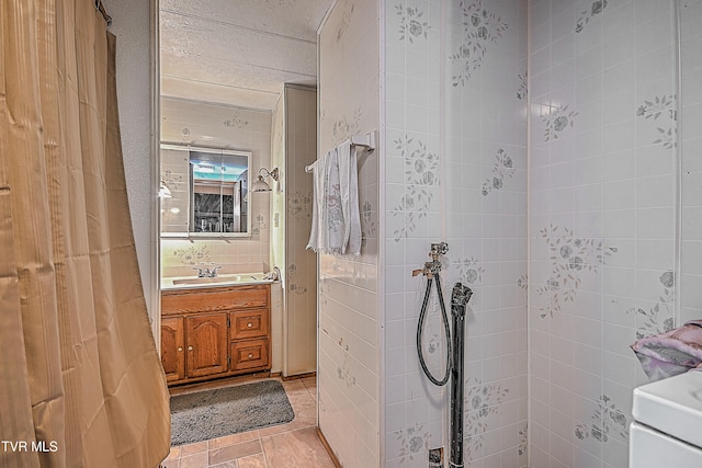 bathroom featuring vanity and tiled shower