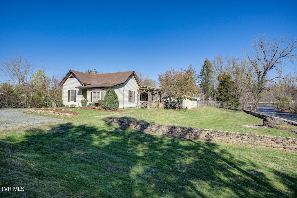 view of side of home with a lawn