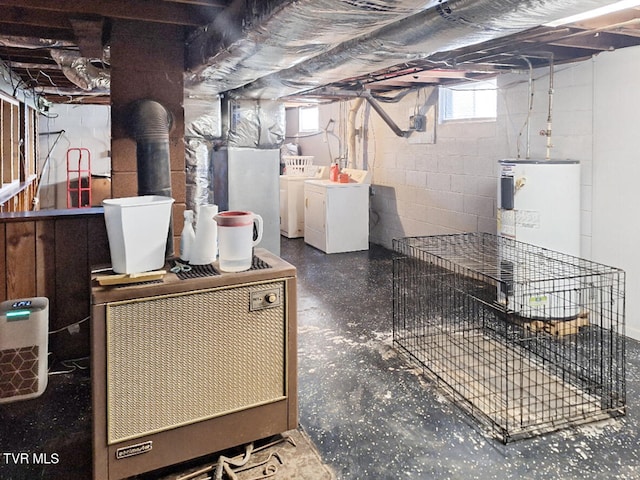 basement with water heater and washer and clothes dryer