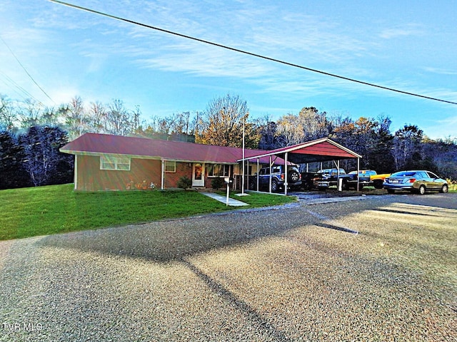 ranch-style house with a carport and a front lawn