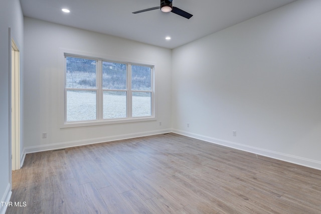 unfurnished room with ceiling fan and light hardwood / wood-style floors