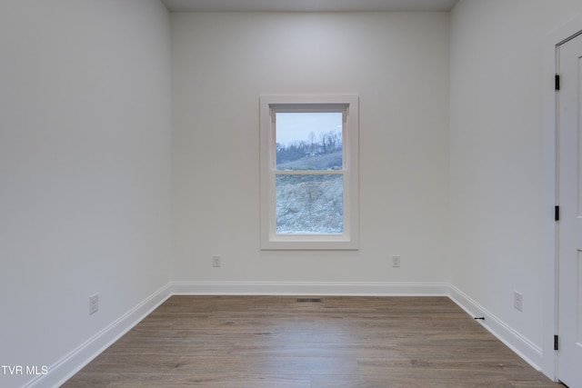 unfurnished room with light wood-type flooring