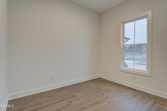 empty room with light hardwood / wood-style flooring