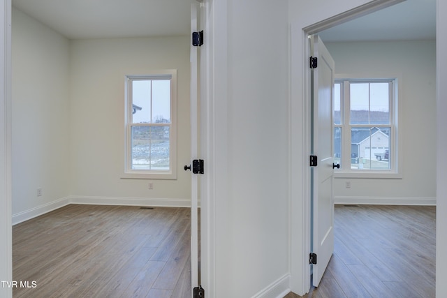 hallway with light hardwood / wood-style flooring