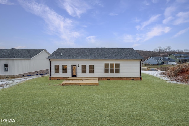 back of house featuring a lawn and a wooden deck