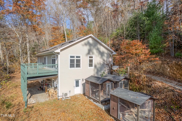 back of house featuring a wooden deck