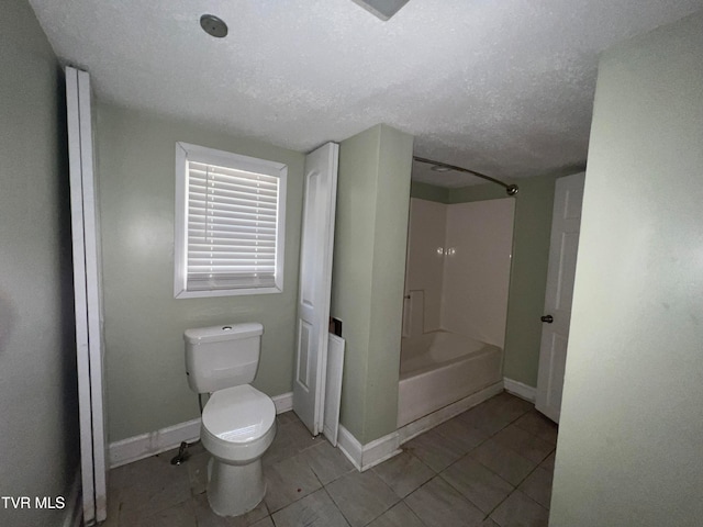 bathroom featuring toilet, bathtub / shower combination, a textured ceiling, and tile patterned floors