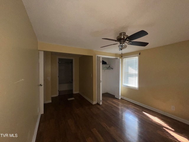 unfurnished bedroom with a closet, dark hardwood / wood-style floors, and ceiling fan