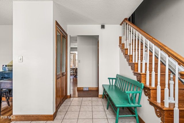 interior space with light hardwood / wood-style floors and a textured ceiling