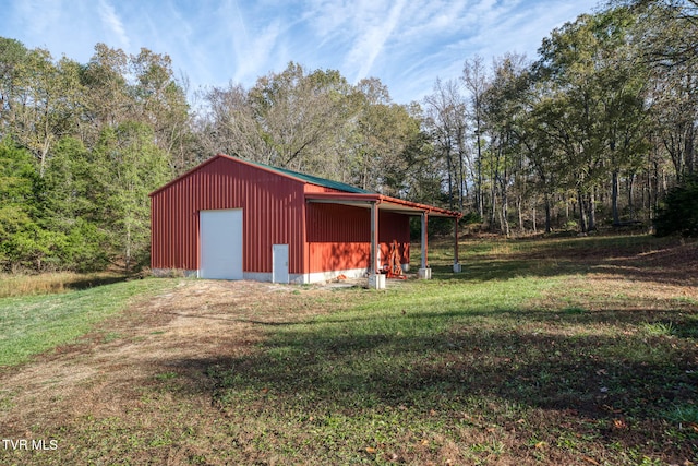 view of outdoor structure with a lawn and a garage