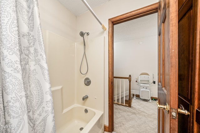 bathroom with a textured ceiling and shower / tub combo