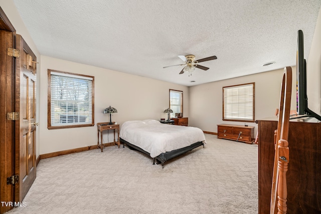 bedroom featuring carpet flooring, a textured ceiling, and ceiling fan