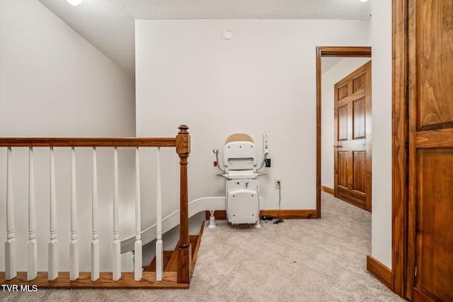 stairs with carpet and a textured ceiling