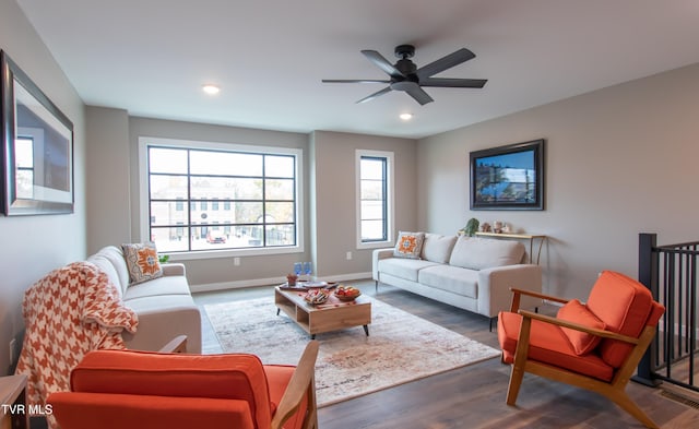 living room featuring hardwood / wood-style floors and ceiling fan