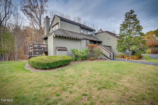 exterior space with a front yard and a wooden deck