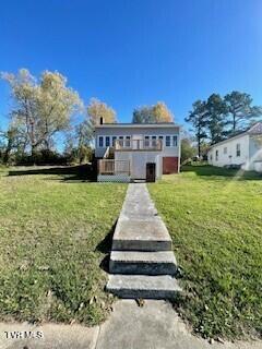 rear view of property with a lawn