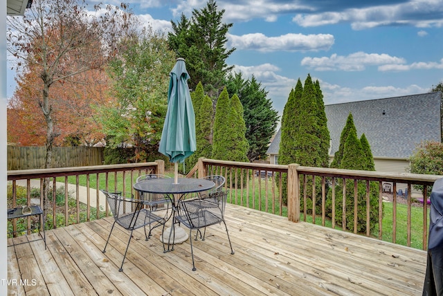 wooden terrace with a yard