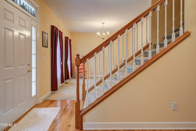 foyer with a chandelier and light hardwood / wood-style floors