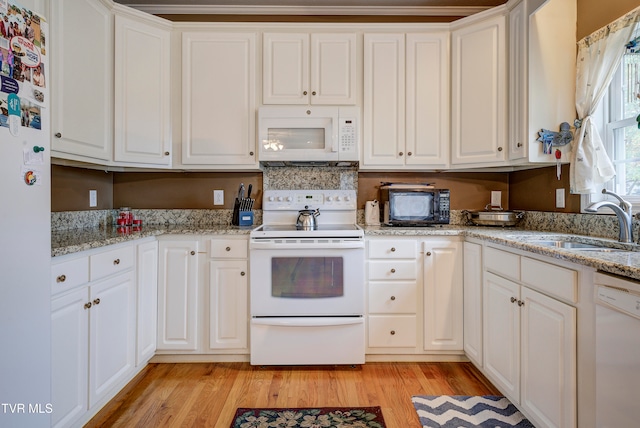 kitchen featuring light hardwood / wood-style flooring, white appliances, and white cabinets