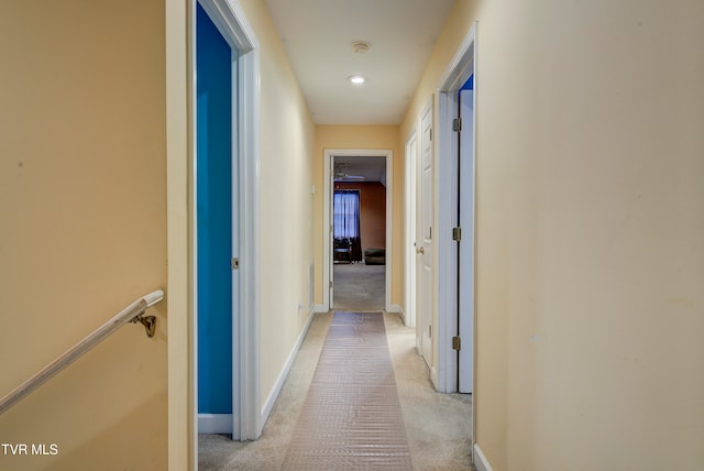 corridor featuring light colored carpet