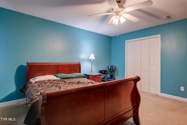 bedroom with light carpet, ceiling fan, and a closet