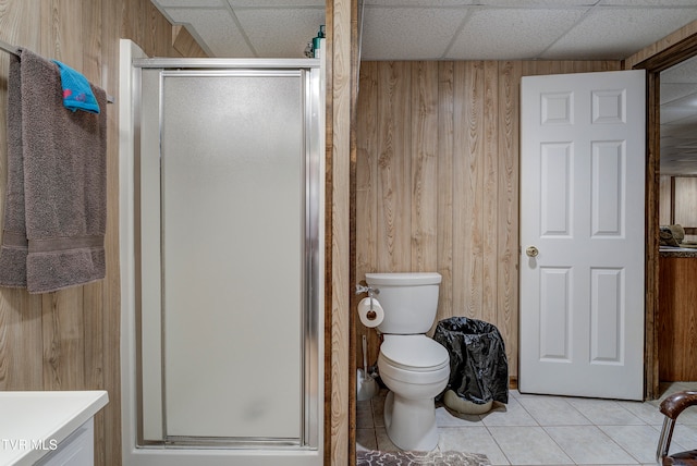 bathroom with wood walls, tile patterned flooring, a paneled ceiling, and vanity