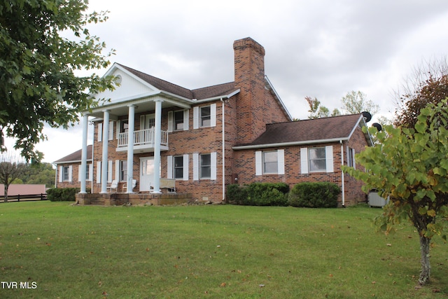 exterior space with a front yard and a balcony