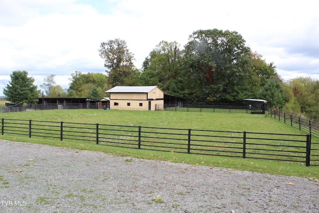 view of yard featuring an outdoor structure and a rural view